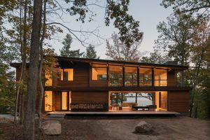 Modern glass cottage on lake with plenty of windows